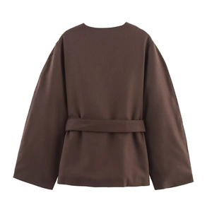 Detail view of the back of a dark brown wool jacket with a matching waist tie belt