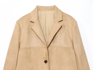 Detail of faux suede jacket showing lapel collar and tortoiseshell button on camel fabric