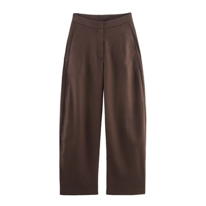 Close-up of high-waisted chocolate brown wide-leg trousers with elegant pleat detail