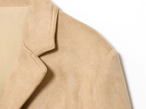 Detailed view of notch lapel and shoulder stitching on khaki faux suede blazer jacket