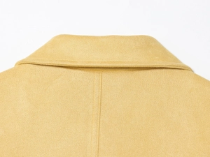 Macro view of the yellow suede coat collar showing precise stitching and premium fabric