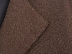 Detailed close-up of dark brown wool fabric texture with contrast inner lining