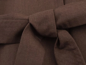 Detail view of deep brown fabric belt knot with visible diagonal twill texture on jacket