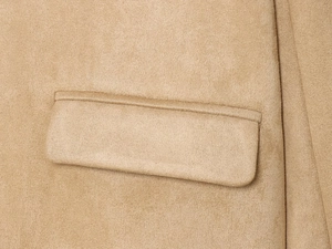 Detailed close-up of a faux suede blazer flap pocket with precise stitching