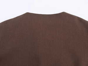 Detailed macro view of the dark brown thick woven fabric texture on a kimono style jacket