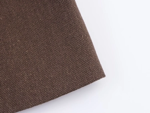 Close-up of deep brown fabric with a thick textured weave for a stylish women's set