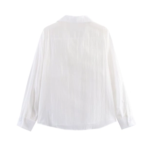 Back view of a white long sleeve shirt with back yoke pleat detail and textured fabric