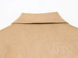 Detailed close-up of notch lapel and precision stitching on khaki faux suede blazer