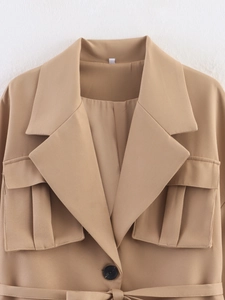 Detailed close-up of khaki casual blazer featuring a large lapel and flap pockets design