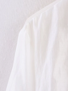 Macro shot of white shirt shoulder seams showing fine woven texture and breathable fabric