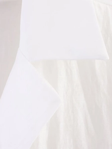 Detail of white shirt fabric showing smooth silk-like texture and neat collar seam