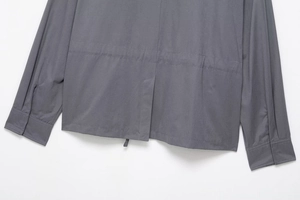 Detail view of the drawstring waist and back slit on a charcoal grey hooded utility set