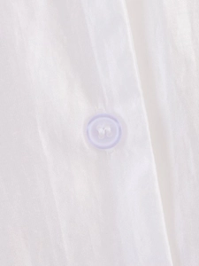 Macro shot of white textured fabric shirt with a lavender translucent 4-hole button