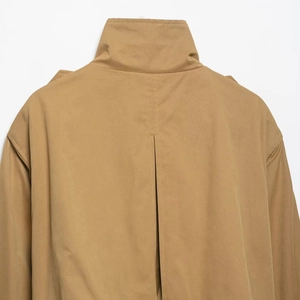 Women's khaki short trench coat with high collar and back vent detail on white background