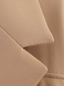 Close-up of khaki notched lapel and high-density twill fabric with precision stitching