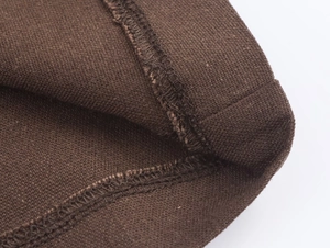 Detail of professional hem stitching and knit texture on dark brown trousers