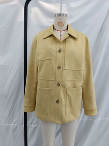 Detail of a ginger yellow faux suede jacket with lapel collar and four utility pockets