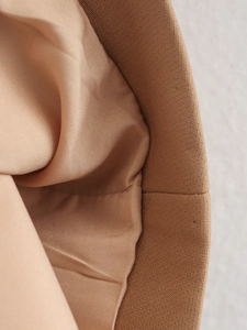 Detailed close-up of khaki jacket stitching with durable outer fabric and smooth lining