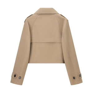 Detail view of the beige short trench coat featuring shoulder epaulettes and storm flap back