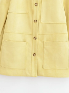Detail of yellow faux suede jacket featuring tortoise buttons and utility patch pockets