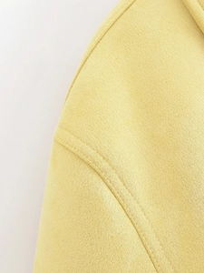Detail of yellow faux suede fabric featuring precise double-stitch reinforced seams