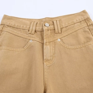 Close-up of khaki straight-leg denim trousers featuring metal button and rivet pockets