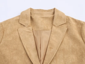 Detail of notched lapel and soft faux suede fabric on the camel long coat jacket