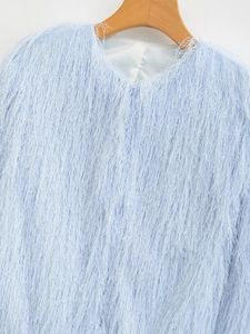 Detail of light blue faux fur jacket fabric with long fringe textures and crew neck