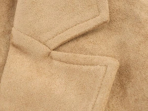 Detail of high-quality double stitching on the collar of camel faux suede long coat