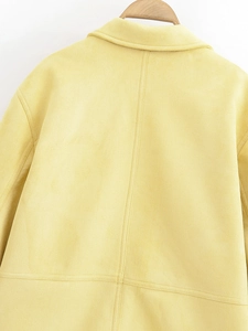 Back view detail of light yellow suede jacket showing lapel and vertical seam structure