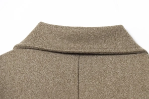 Close-up of classic lapel collar and thick wool texture on a short autumn coat
