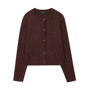 Detailed close-up of dark brown knit cardigan with classic crew neck and ribbed cuffs