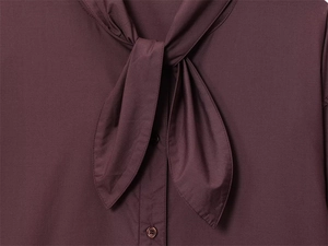Close-up of deep purple poplin shirt collar with elegant pussy-bow tie and button details