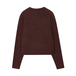 Macro detail of dark brown knit sweater back showing ribbed cuffs and wool texture