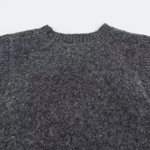 Chic dark grey knitted vest featuring a ribbed round neckline and soft textured wool blend