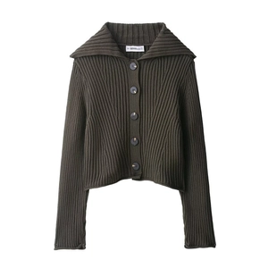 Detail of dark olive ribbed knit cardigan showing large collar and marbled buttons