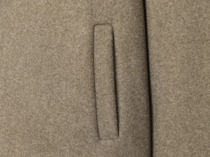 Detailed macro shot of high-quality wool fabric texture and flat welt pocket craftsmanship