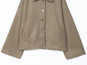 Close-up of taupe wool coat featuring lapel collar and tortoiseshell button details
