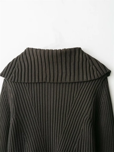 Close-up of premium ribbed knit texture and wide collar on dark grey autumn sweater