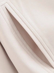 Close-up of side pocket on pink jacket showing high-quality stitching and woven fabric texture