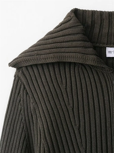 Detailed close-up of dark olive ribbed knit cardigan with collar and brand label