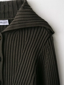 Detailed view of dark brown ribbed knit cardigan with collar and size label details