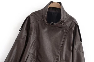 Close-up of litchi textured dark brown PU leather jacket with high collar and epaulets