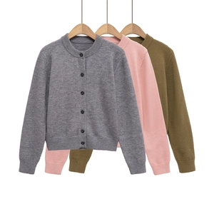 Detail of round neck cardigans in grey, pink and green with ribbed cuffs and buttons