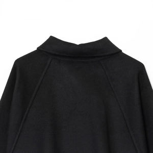 Back view of black wool blend fashion jacket featuring raglan sleeves and premium texture