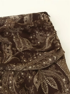 Close-up of brown floral print skirt fabric with hidden side zipper detail