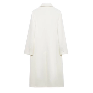 Detail view of cream white coat back featuring cuff buttons and center back hem slit