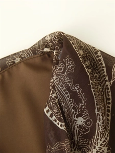 Macro view of vintage paisley print on brown fabric with smooth inner lining and stitching