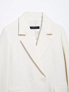Detailed close-up of premium white wool coat collar with classic double-breasted buttons