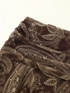 Detailed close-up of brown paisley print on semi-transparent chiffon fabric